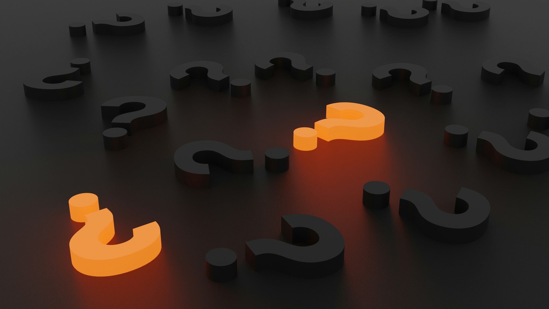 A 3-D rendering of question marks on a black background.   Most of the question marks are black, but two are glowing orange.  Photo by Laurin Steffens on Unsplash.