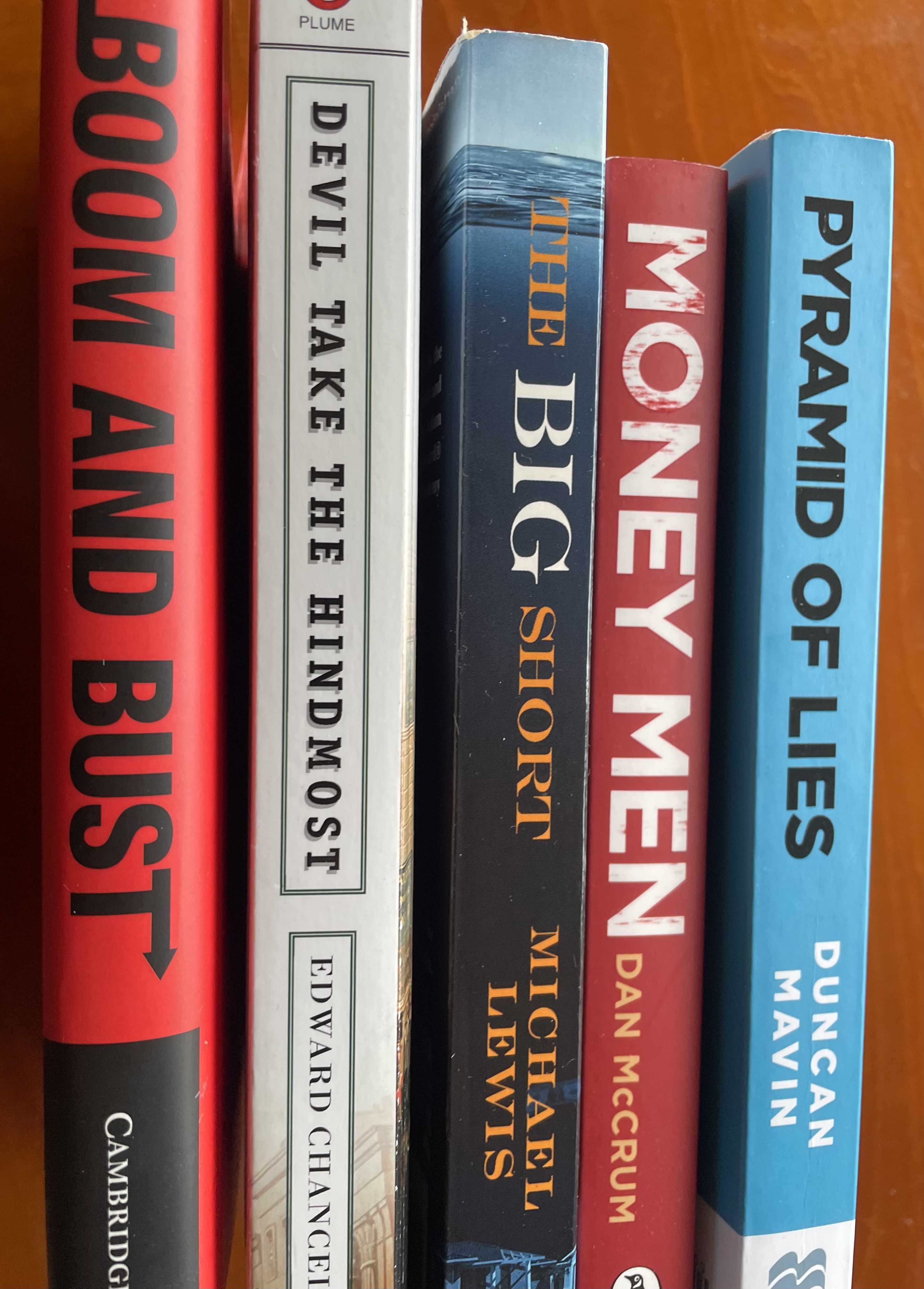 The spines of five books: Boom and Bust ; Devil Take the Hindmost ; The Big Short ; Money Men ; Pyramid of Lies.